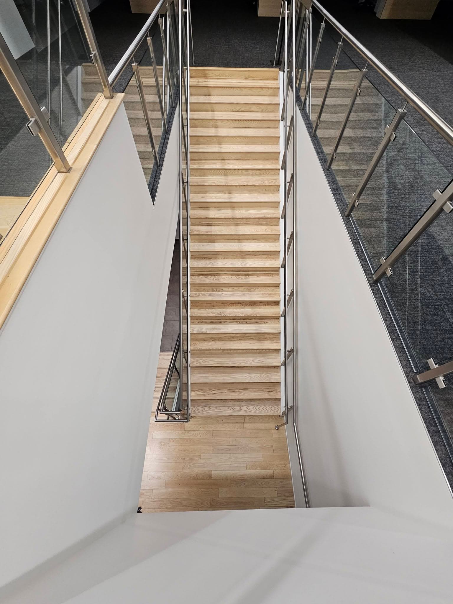 Overhead view of commercial hardwood stairs at Mazda Toyota manufacturing in North Alabama, a stair replacement by Alabama Hardwood Restoration