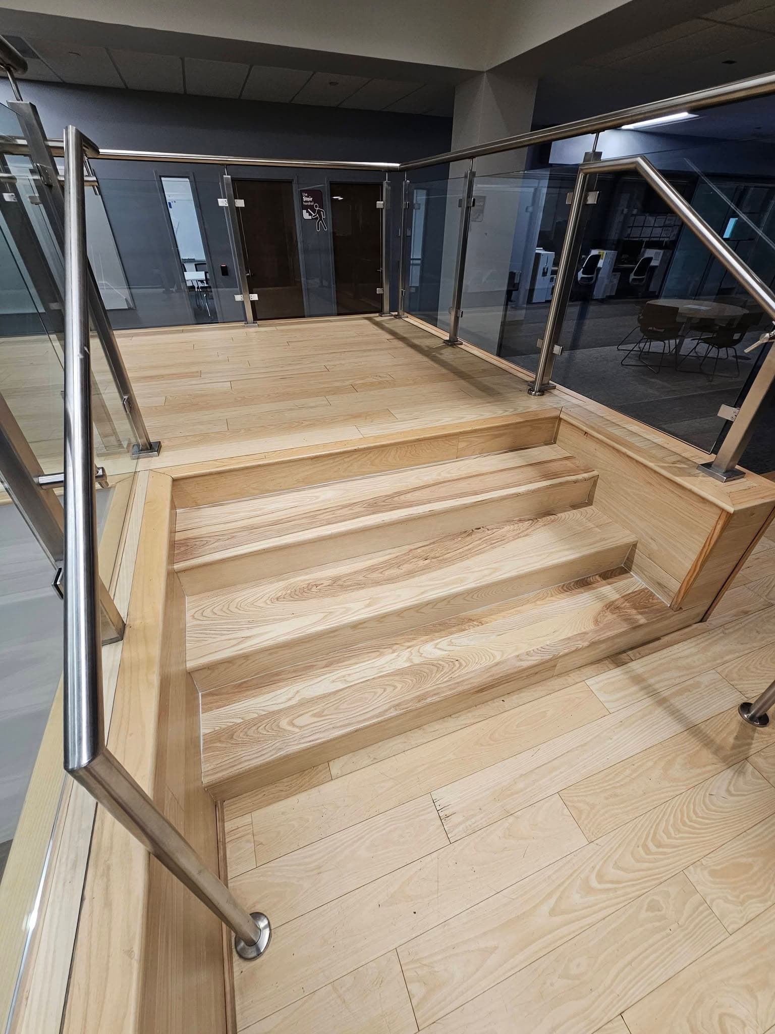 Hardwood landing and short commercial stairs at Mazda Toyota manufacturing in North Alabama, a stair replacement by Alabama Hardwood Restoration
