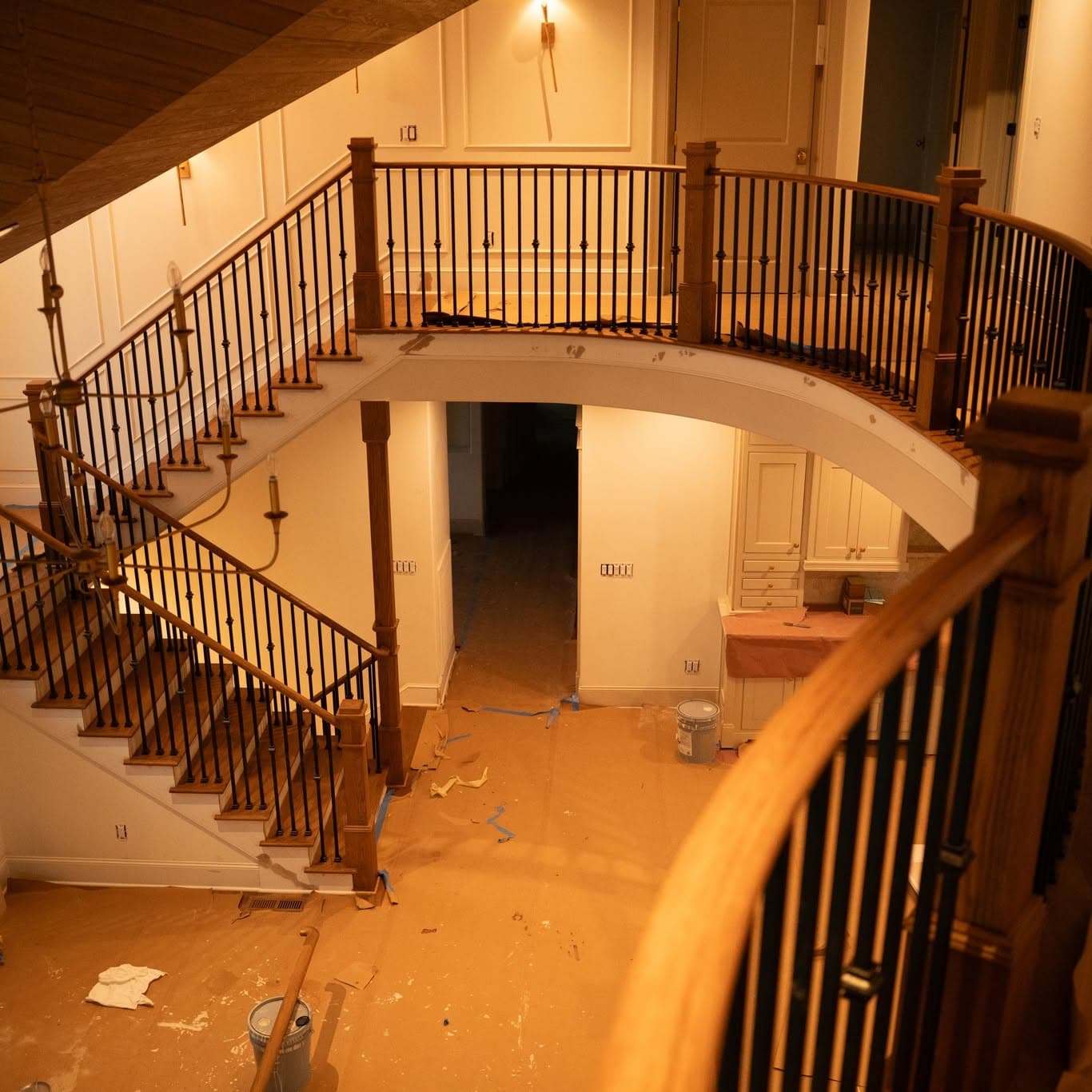 New-construction hardwood staircase with oak treads, white risers, and black metal balusters, a job by Alabama Hardwood Restoration